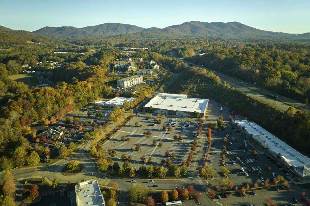 Aerial view grocery shopping mall and many colorful cars parked on parking lot